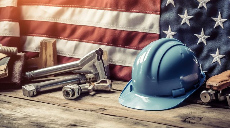 Image of a woodern work bench with a hard hat and various tools on behind an American flag to support reshoring article