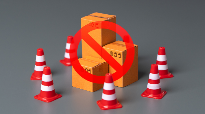 Model cardboard packages circled by red cones and circle 'stop' sign to support Celonis supply chain challenges article