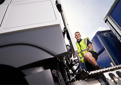 Wincanton Logistics driver standing between cab & trailer