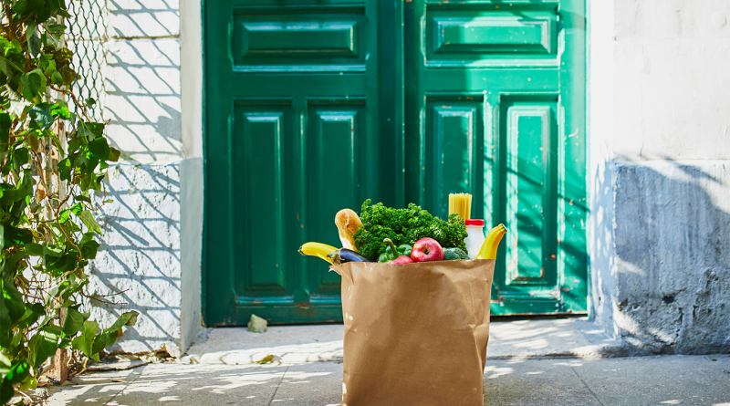 Grocery bag outside door to support Save a Lot grocery delivery article