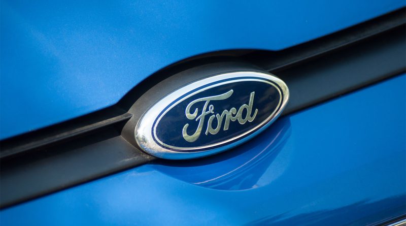 Ford pickup trucks moving through an advanced automotive manufacturing and logistics facility