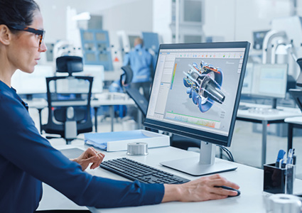 a person working on a computer-aided design (CAD) model of a mechanical engine component