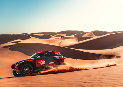 a specialized MINI John Cooper Works (JCW) Rally car navigating a desert landscape