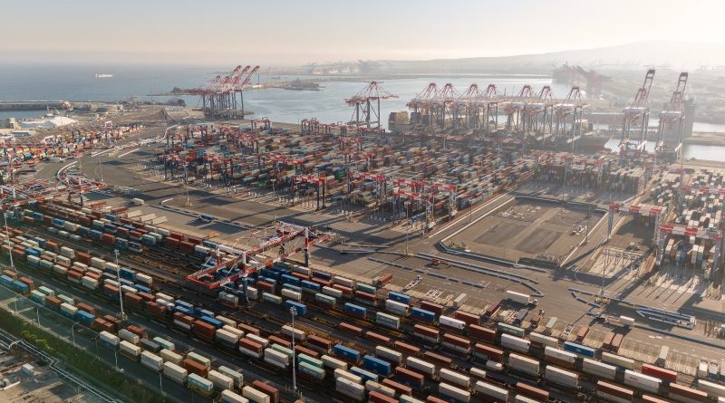Shipping containers and cargo operations illustrating the impact of tariff policy on global supply chains and sourcing decisions.