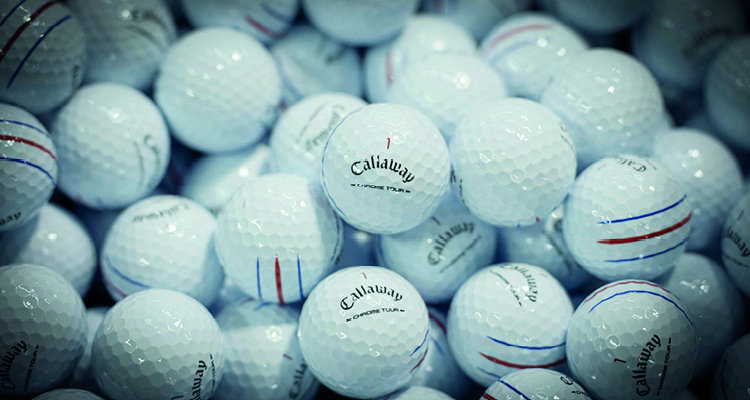 a close-up shot captures a dense, jumbled pile of clean white Callaway golf balls