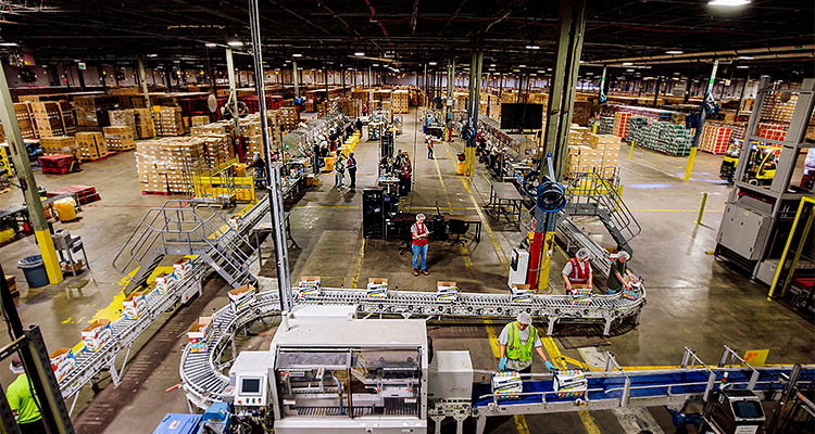 Gilmer prepares to celebrate 40 years in business in its brand-new headquarters high-angle, wide shot captures the bustling activity inside a massive, fully operational distribution warehouse or fulfillment center