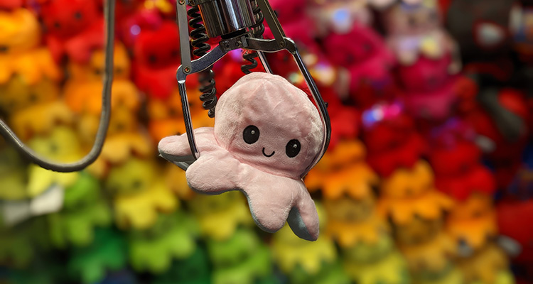 From seaside arcades to global attractions, HB Leisure continues to raise the stakes a close-up shot captures a plush toy being successfully grabbed inside a carnival crane game