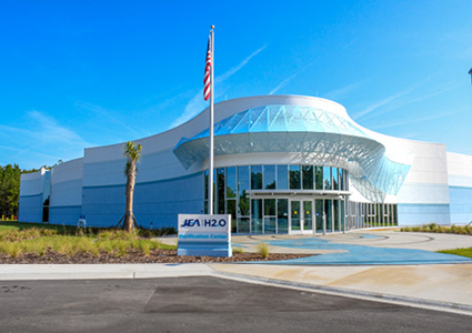 the bright, modern exterior facade of a commercial facility on a clear day.