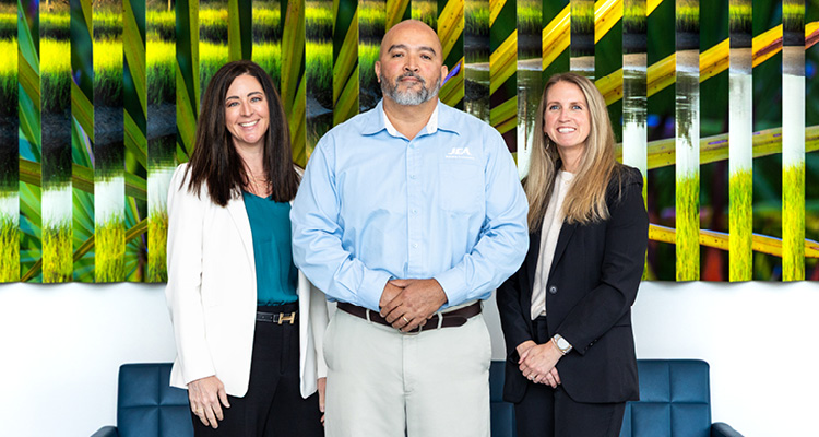 JEA is investing $4 billion to modernize infrastructure, protect resources, and keep Jacksonville powering ahead three individuals standing side-by-side in a well-lit indoor environment