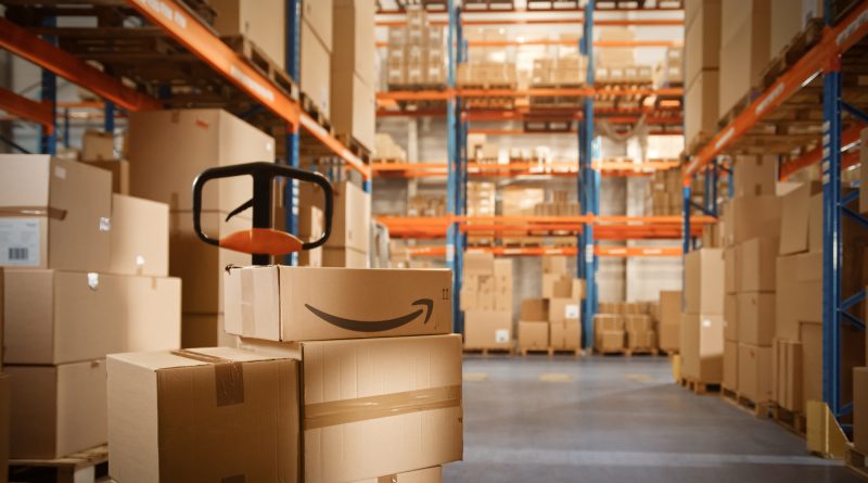 Amazon warehouse interior, representing new automated systems and AI-driven workforce planning dashboards.