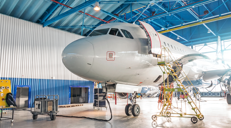 Airplanes under repair in a maintenance hangar.