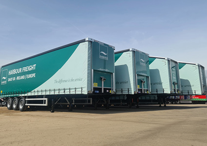 teal and white curtainsider semi-trailers operated by Harbour International Freight