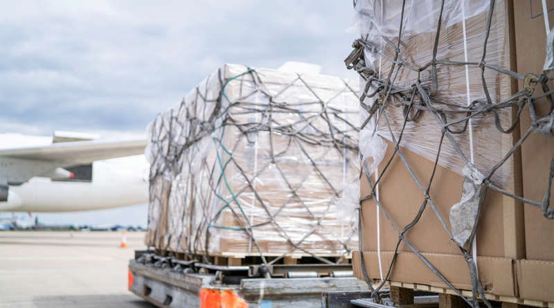 Air freight cargo on dolly trailer waiting to be loaded onto aircraft