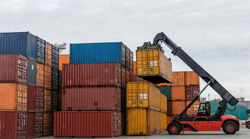 Mobile stacker handler in action at a container terminal.
