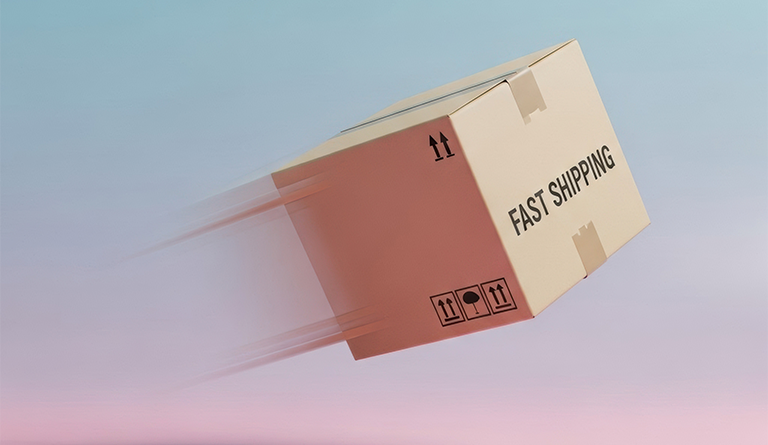 Alt text for this image Cardboard shipping box labelled “Fast Shipping” moving at speed against a pastel background, symbolising efficient logistics, rapid delivery and supply chain operations.